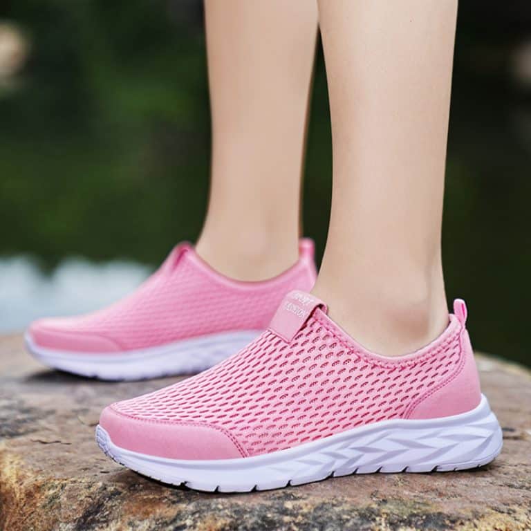 Breathable hot pink mesh sneakers for women, with a comfortable white sole and a slip-on style.