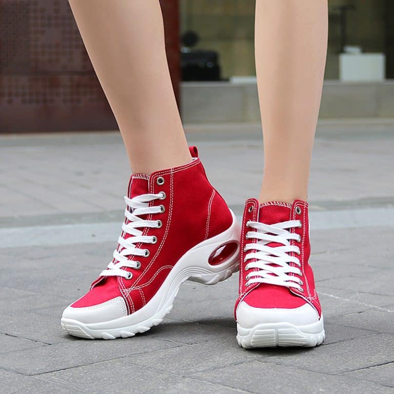 Red high-top sneakers for women with white sole and white stitching details.