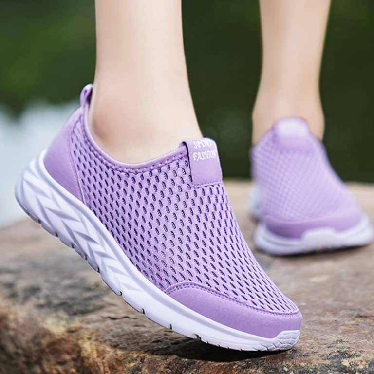 Lightweight slip-on orthopedic shoes for women in pale purple color, with breathable mesh and wavy white sole.