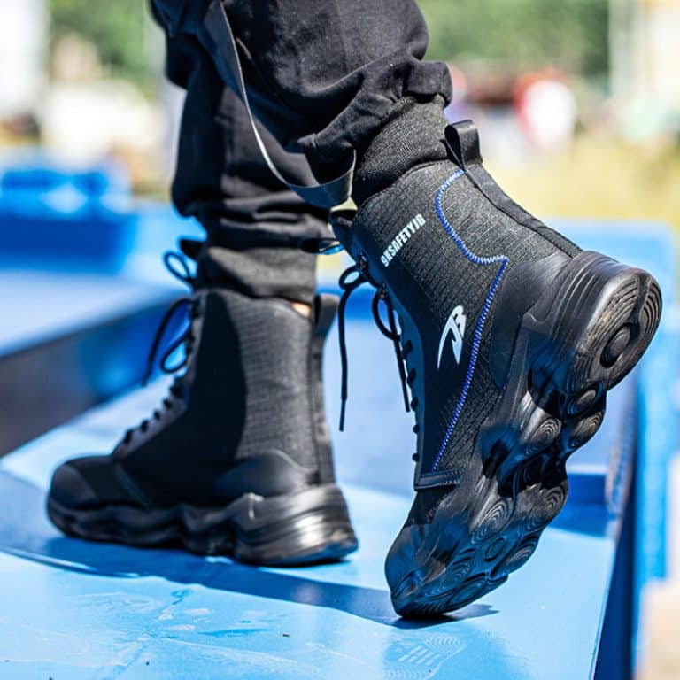 Black high-top men's safety boots with blue details and black laces, laid out.
