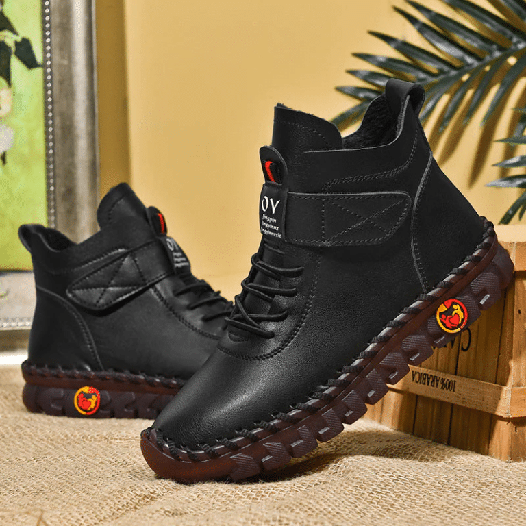 Black high-top boots for women with thick soles and stitching details.