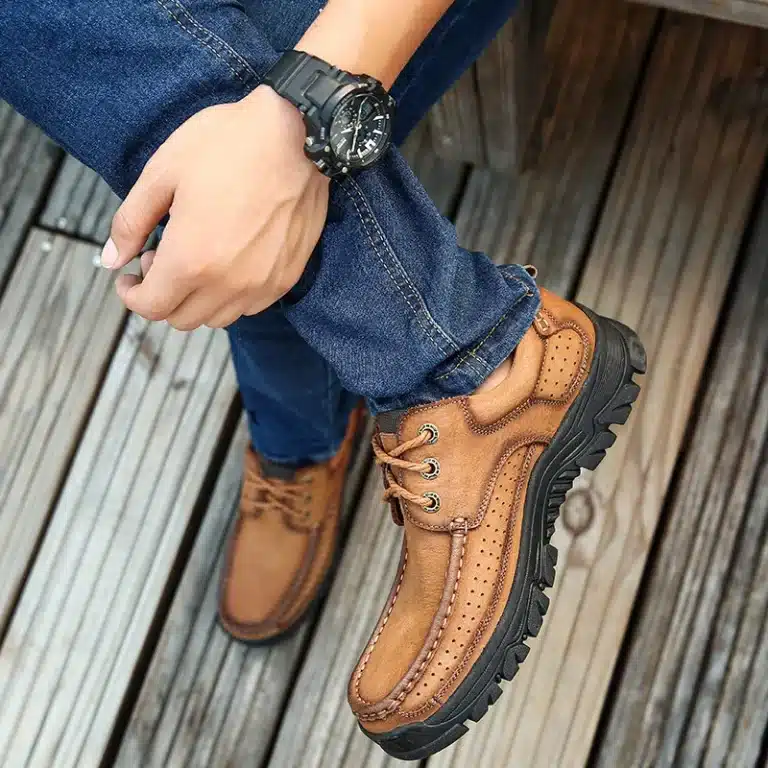 Rear view of a person walking with brown lace-up orthopedic shoes seen from above.