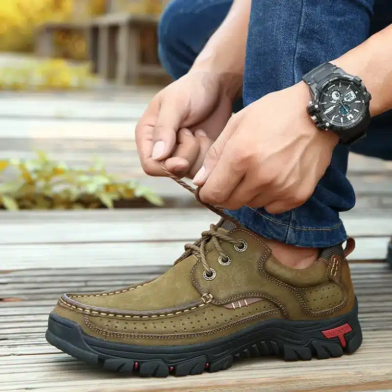Close-up view of a person lacing green orthopedic shoes.