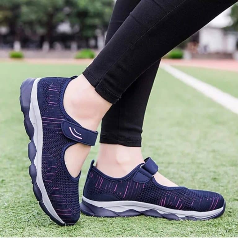 Women's velcro shoes, navy blue with patterns on a white and gray sole.