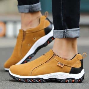 Comfortable walking shoes for men in brown suede with white sole and black and red details.