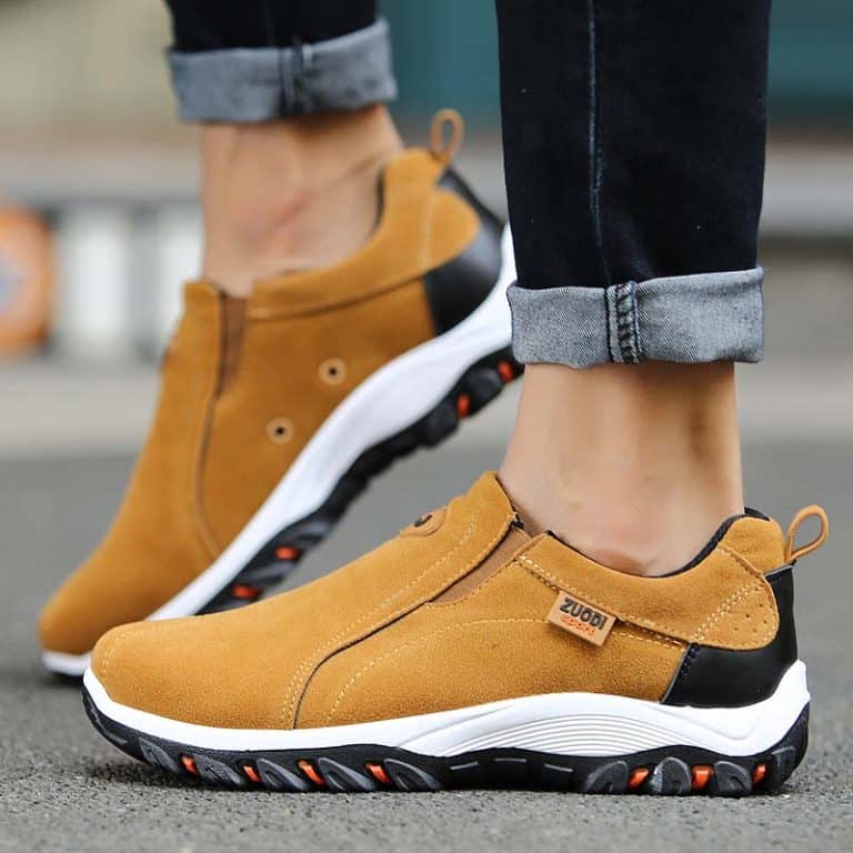 Comfortable walking shoes for men in brown suede with white sole and black and red details.