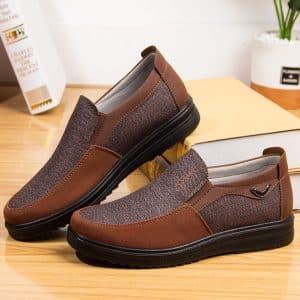 Dark brown orthopedic dress shoes with elastic band and metallic detail.