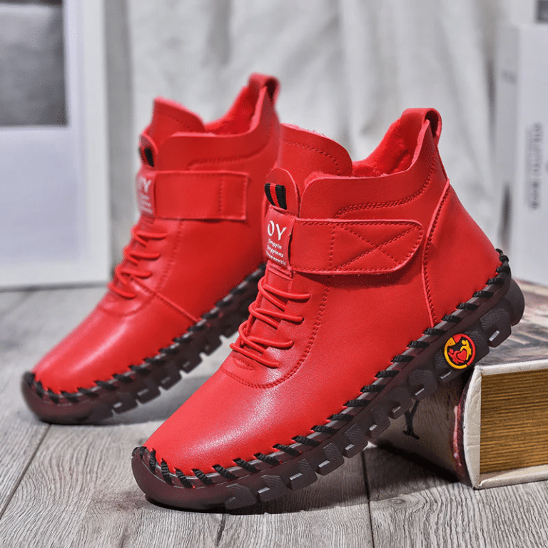 Red high-top shoes with cleated soles and lace-up closure.