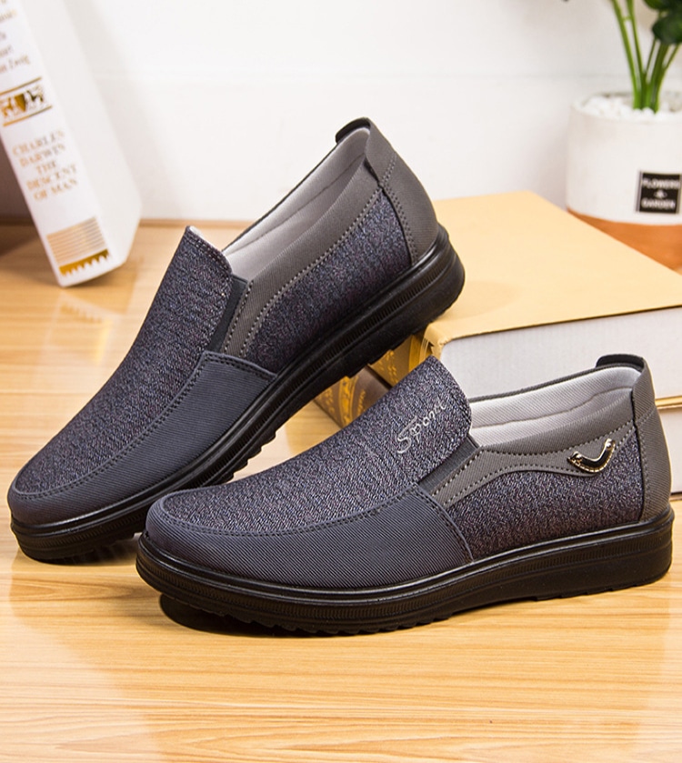 Black orthopedic orthopedic shoes with elastic inserts and small metal decoration.