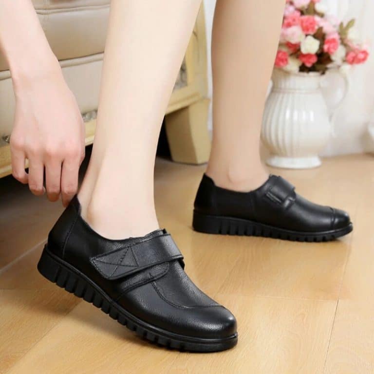 Orthopedic shoes for hallux valgus women in black leather with lug sole and velcro closure.