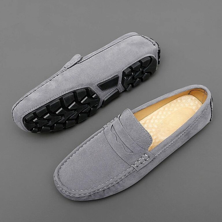 Orthopedic shoes for men with gray rubber soles on a gray background.