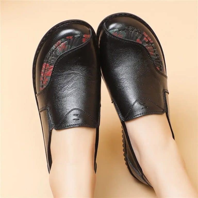 Black loafers for women with wide feet featuring a floral interior and thick sole.