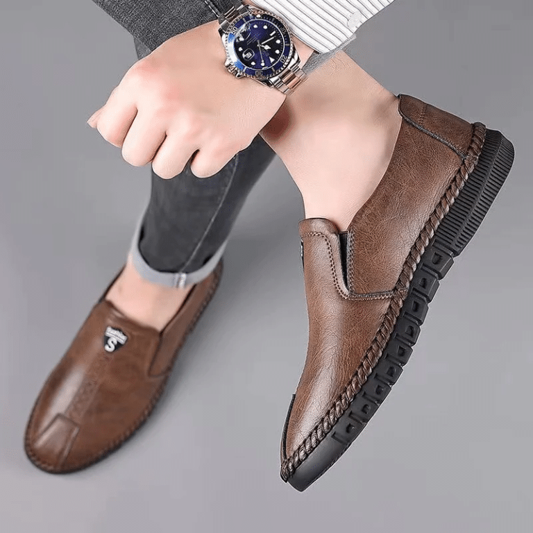 Orthopedic brown leather moccasins for men, worn with an elegant wristwatch.