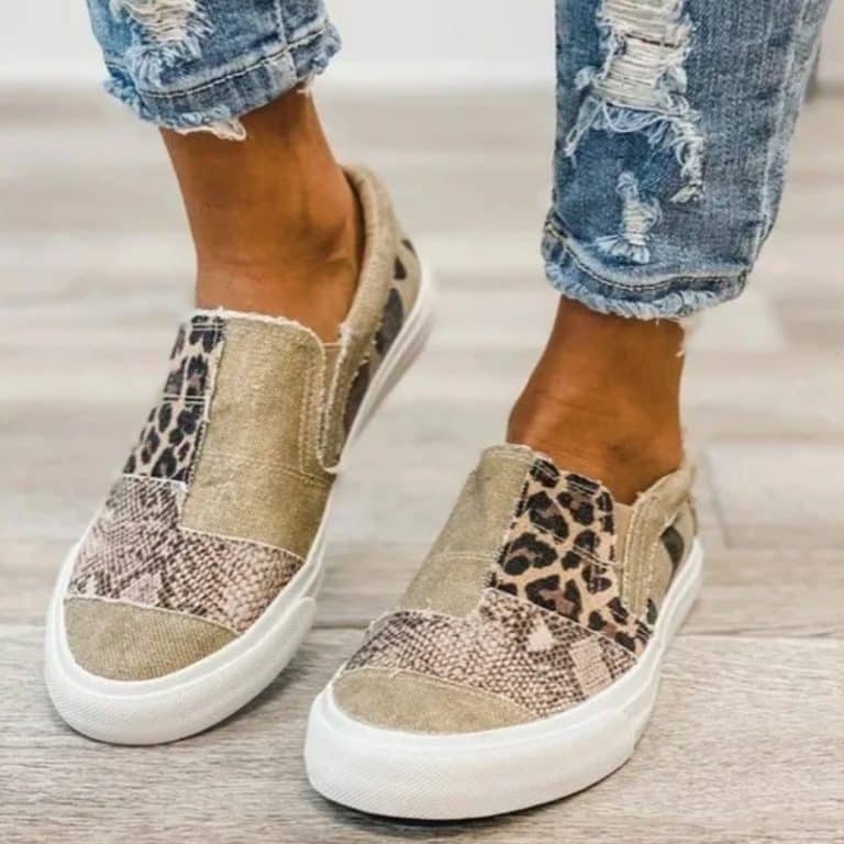 Pair of casual canvas shoes with animal print for women on an indoor background