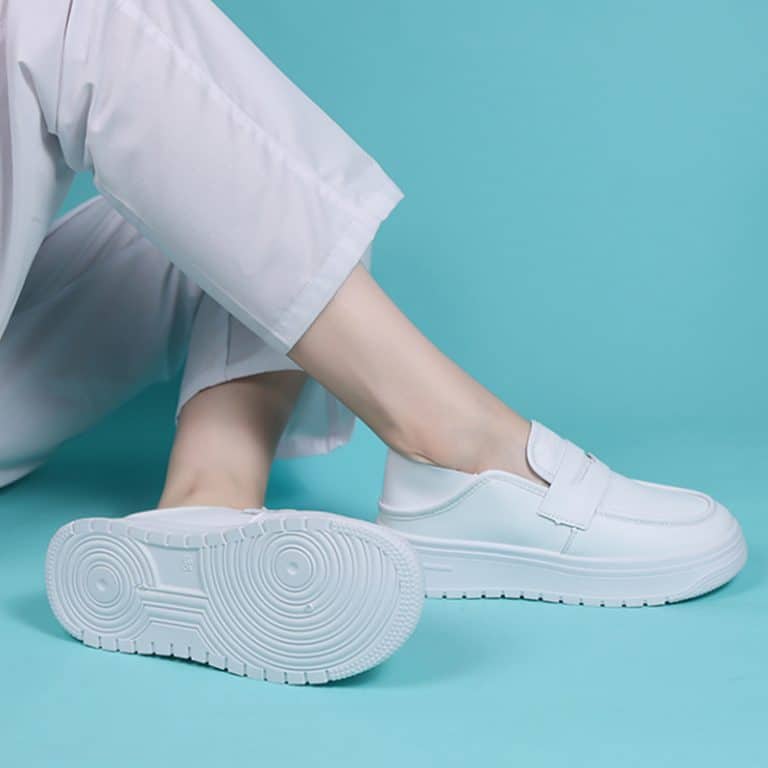 Pair of women's white leather platform loafers, viewed from above.