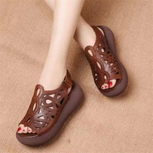 Pair of wedge sandals with cut-out design on top.