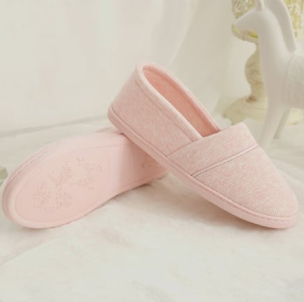 Pale pink slipper with comfortable insole and sleek design.