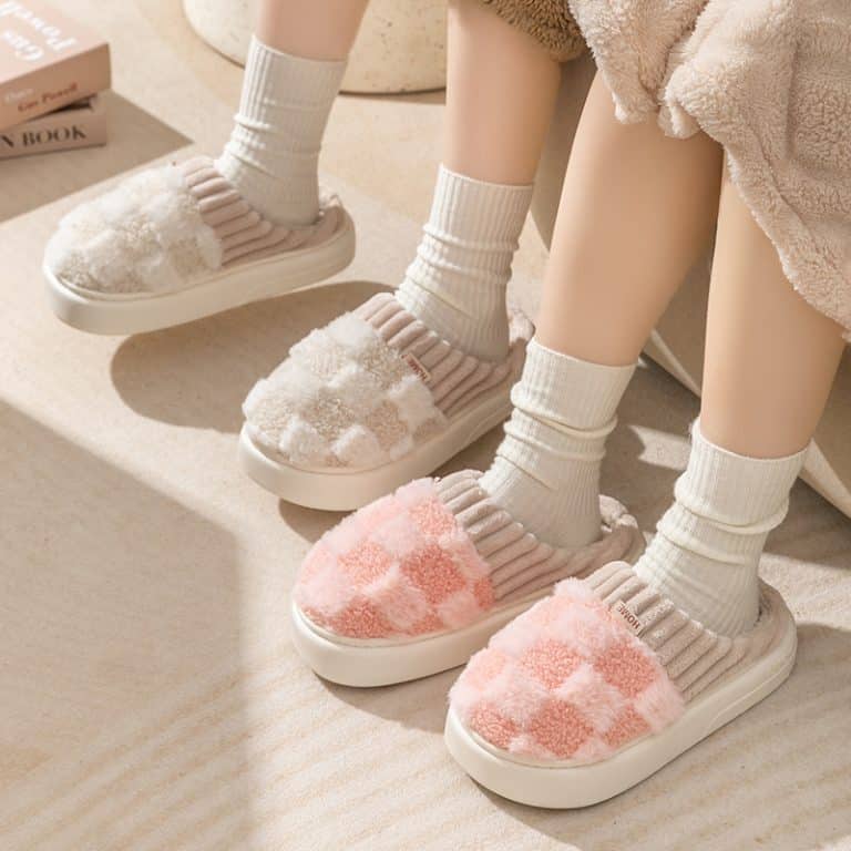 Warm orthopedic slippers for women in beige and pink, worn with high white socks
