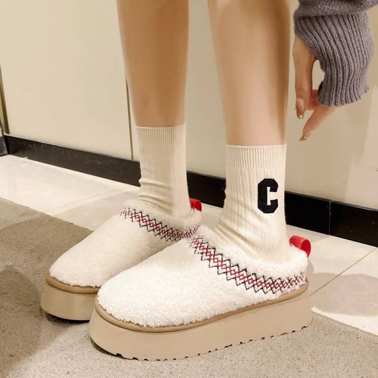 Women's orthopedic slippers in beige sheep wool with a platform sole and a red tongue.