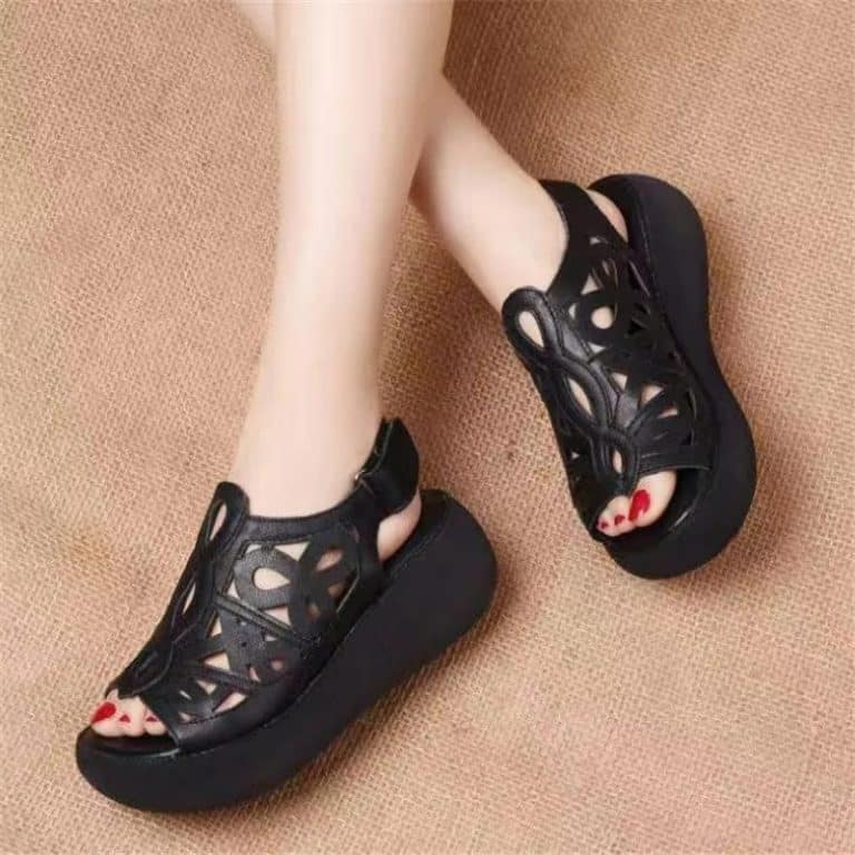 Black wedge-heeled sandals with straps and cutouts for maximum breathability.