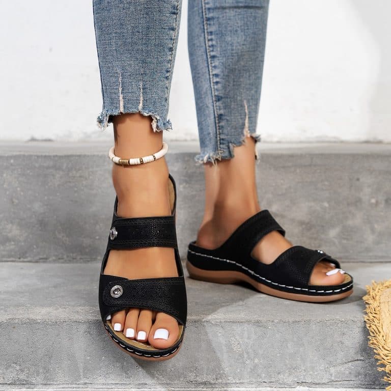 Black women's sandals with orthopedic sole, open back and adjustable straps.