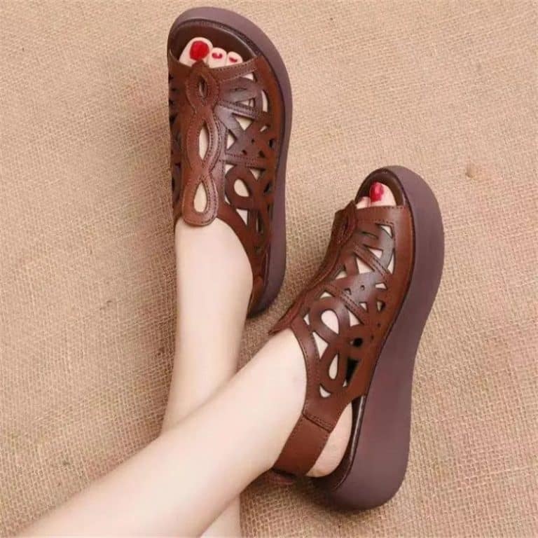 Brown orthopedic women's sandals with cut-outs and wedge heel.