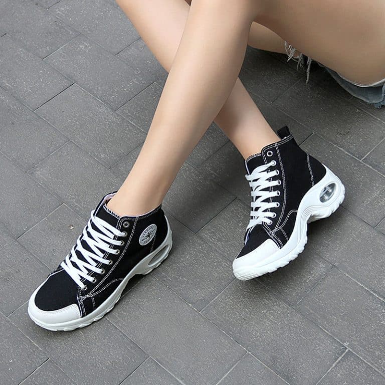 High-top sneakers for women in black with white cushioning sole.