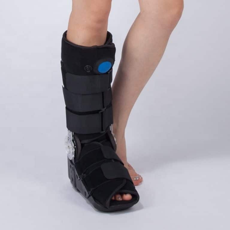 Postoperative black ankle boot with inflation mechanism.