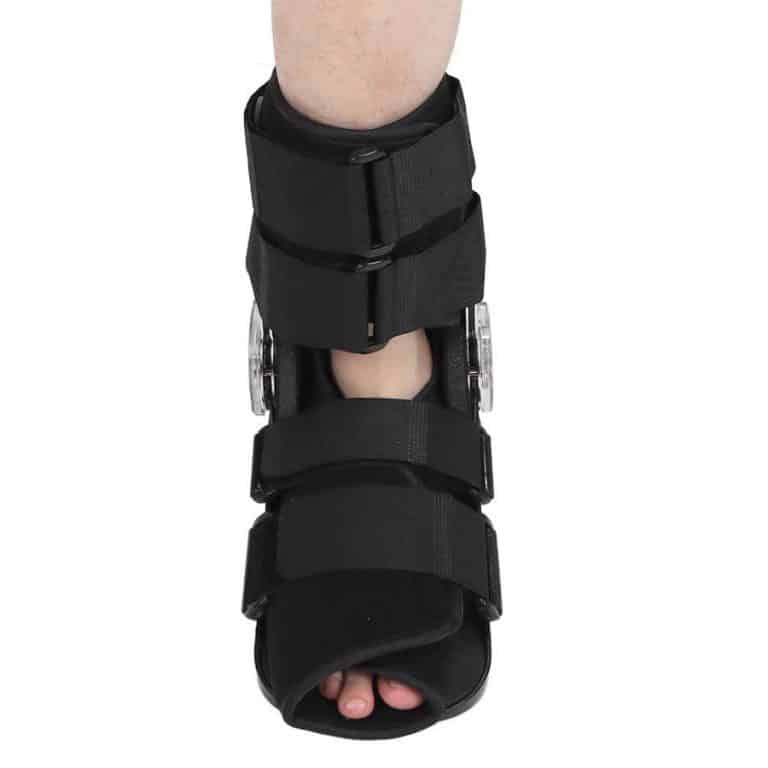 Medical ankle boot worn on the foot with tightening mechanism.