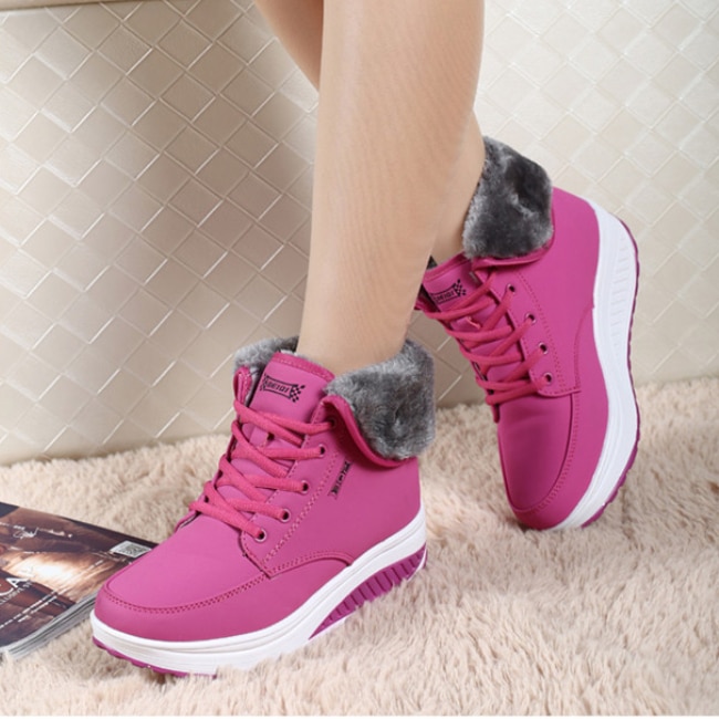 Pink boots with thick white soles and gray fur trim.