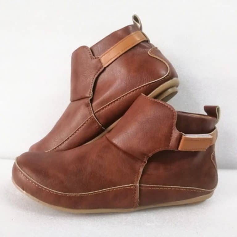Brown leather ankle boots with light brown elastic strap and back loop.