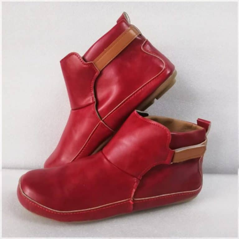 Burgundy red leather ankle boots with light brown elastic strap.