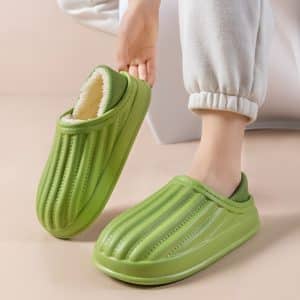 Orthopedic slipper for women in green, worn, showing the inner faux fur lining.