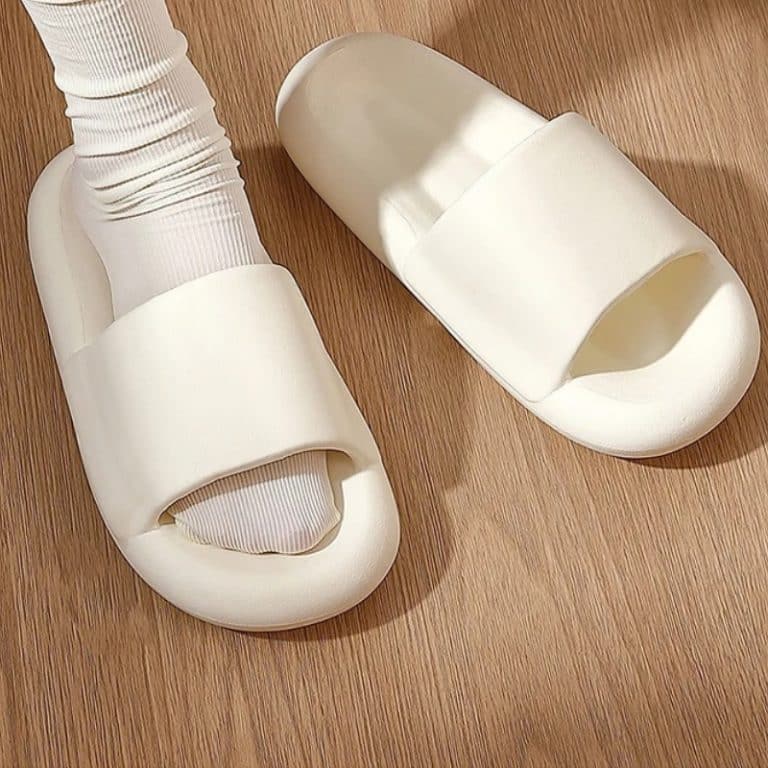 Cream-colored orthopedic slides worn with white socks.