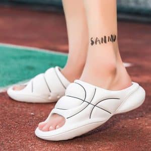 Orthopedic flip-flops for flat feet men in white worn, side view.