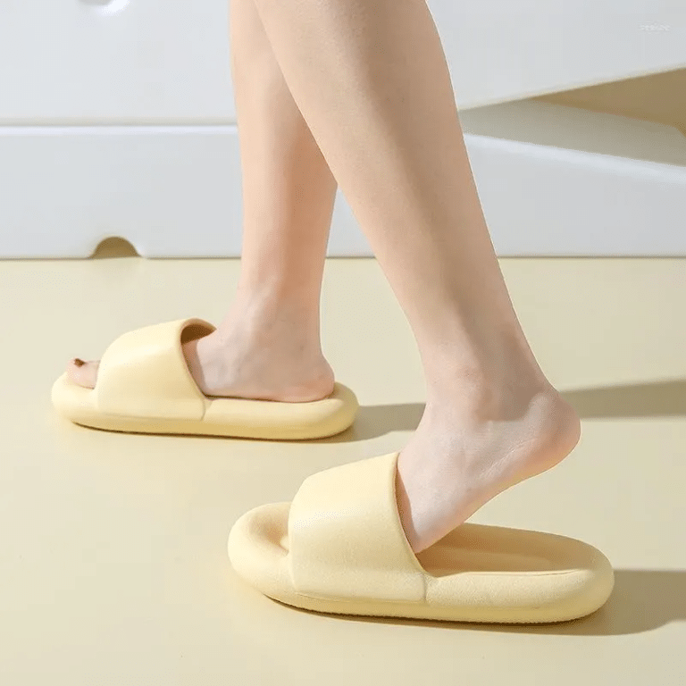 Light yellow unisex orthopedic slides with a thick sole and a wide strap on top.