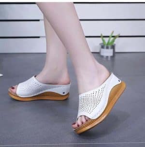 White airy sandals with wooden sole, comfortable for summer.