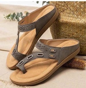 Orthopedic suede sandals for women with gray straps and metallic buttons.