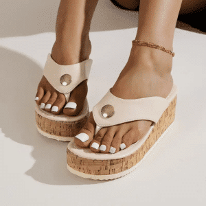 Orthopedic sandals for women with cork sole, wide beige strap, and metallic detail.