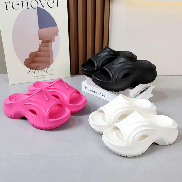 Trio of women's orthopedic flip-flops in pink, white, and black, showcased against an interior decor background.