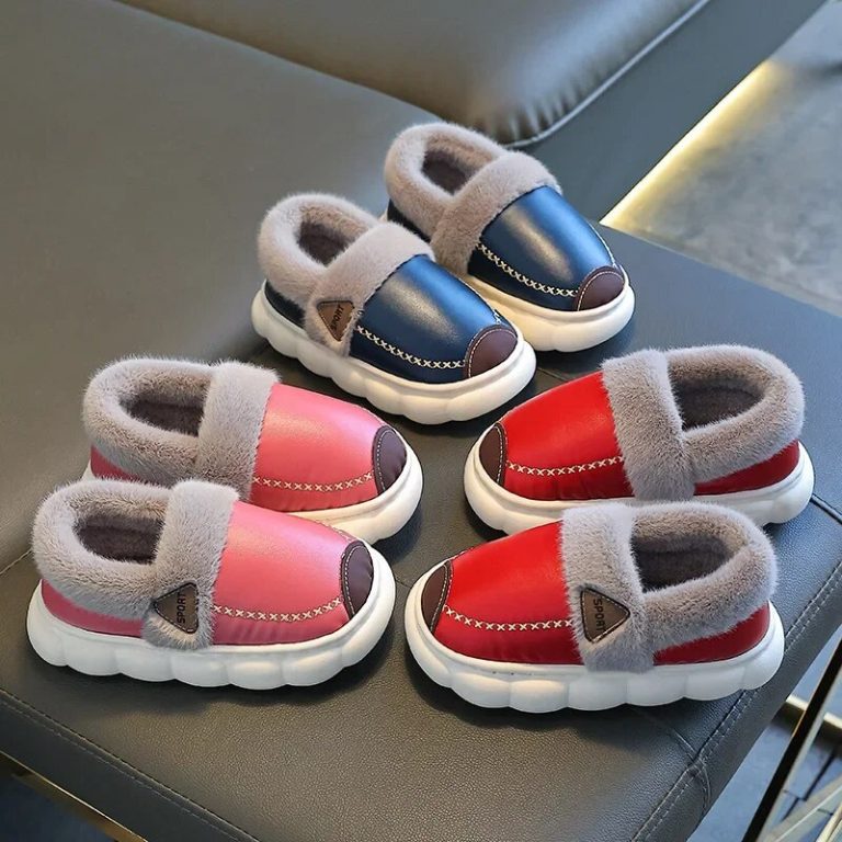 Three pairs of slippers on a sofa, in blue, pink, red, and black with gray lining.